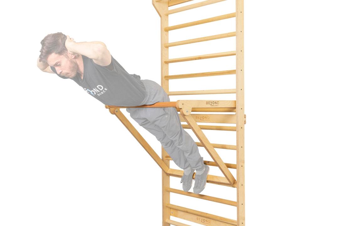 Adjustable pull-up dip attachment in a central position with athlete performing back crunches for core development.